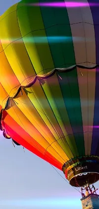 Get ready for an extraordinary phone experience with this vivid live wallpaper featuring a colorful hot air balloon floating in the sky