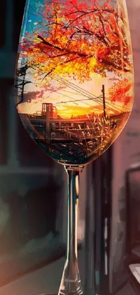 This phone live wallpaper features a stunning photorealistic image of a glass of wine on a table during autumn, with city reflections in the background