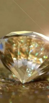 This phone live wallpaper features a stunning close-up of a diamond on a table