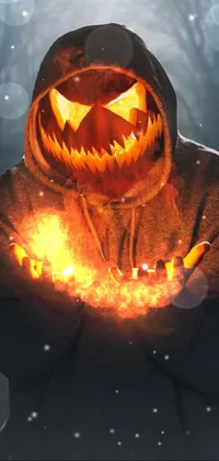 This phone live wallpaper showcases a spooky avatar image of a person wearing a black hoodie while holding a lit-up jack o lantern