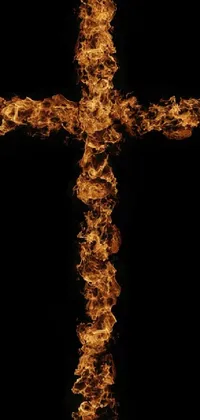 This live wallpaper showcases a remarkable cross, created entirely with fire, against a dark black backdrop