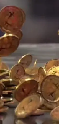 This dynamic live wallpaper features a pile of glistening coins sitting atop a wooden table