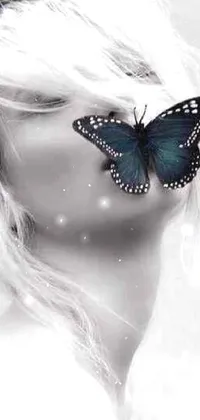 The phone live wallpaper boasts a mesmerizing artwork of a beautiful blonde woman with a butterfly perched on her face