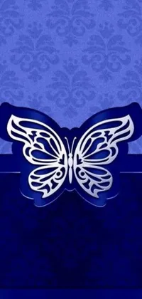 This stunning phone live wallpaper features a close-up of an intricately detailed butterfly in silver and sapphire hues on a calming blue background