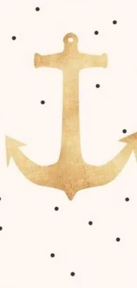 Elevate your phone's look with a charming gold anchor live wallpaper