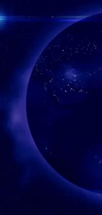 This live wallpaper for iPhone 15 showcases a view of the Earth from space at night, with a brilliant blue and green globe glowing brightly against a dark background