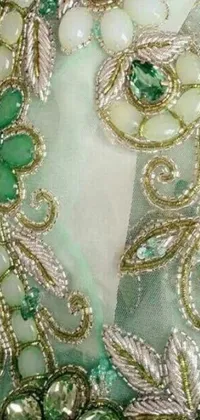 This live wallpaper features a flowing green and white dress with intricate beaded embroidery inspired by Arabesque patterns