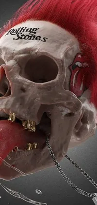 This dynamic phone live wallpaper features a unique and eye-catching image of a skull with fiery red hair protruding from its mouth, bringing a touch of surrealism to your device