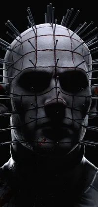 This dynamic live wallpaper captures the essence of avant-garde with a stunning close-up of a person wearing a pinhead mask