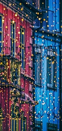 This dynamic phone live wallpaper showcases two vibrant buildings side by side, decorated with street art, lively colors, and enchanting details such as hanging wires and twinkling fairy lights