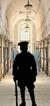 This phone live wallpaper features a captivating silhouette of a man standing in a prison hallway, with ominous cell bars in the background