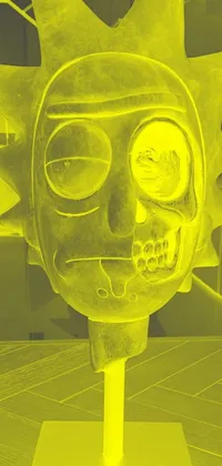 This phone live wallpaper features a sculpture of a rick in yellow metal and glowing with intricate details