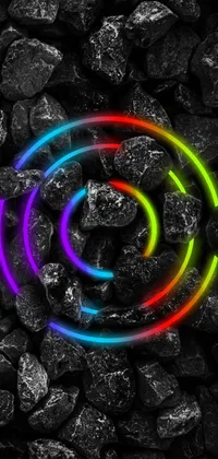 This digital art live wallpaper features a rainbow ring in a pile of rocks