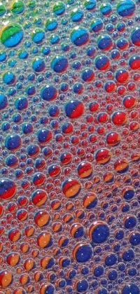 Add a pop of color to your phone with this delightful live wallpaper! Watch bubbles of rainbow liquids dance magically on top of a table