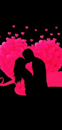 This phone live wallpaper depicts a romantic scene of a couple sharing a kiss in front of a heart-shaped tree with pink hearts on its branches
