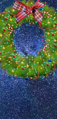 Enhance your phone with this magical Christmas wreath live wallpaper featuring a close up of the traditional wreath on a blue background designed with stunning digital rendering technique