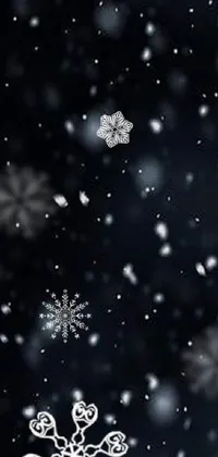 This live wallpaper for your phone showcases a beautiful black and white digital rendering of snow flakes