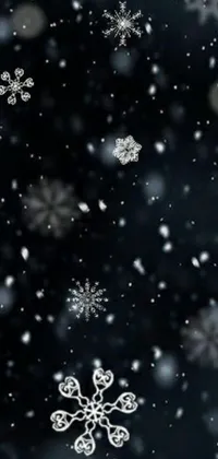 This phone live wallpaper depicts a gorgeous snowy winter night with an abundance of cute snowflakes against a black background