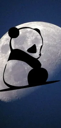 This live phone wallpaper features a playful and cute panda bear silhouette against a full moon backdrop