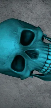 Decorate your phone with a stunning live wallpaper featuring a symmetrical turquoise skull resting on cemented flooring