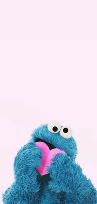 This phone live wallpaper showcases a charming stuffed animal with a pink bow, paired with an image or design and possibly a playful Cookie Monster