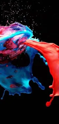 Enhance your phone’s look with this live wallpaper featuring vivid red and blue paint splashes merged together in an elegant display of color