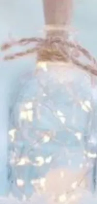 This mobile live wallpaper showcases a stunning glass bottle with a wrapped string motif