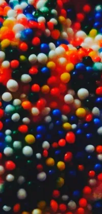 This abstract phone live wallpaper showcases a colorful pile of sprinkles arranged in a pointillism-style
