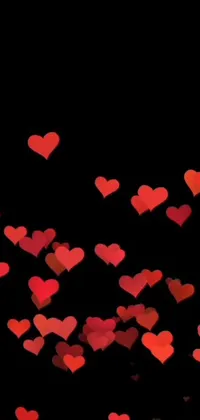 This live wallpaper features a captivating scene of red hearts floating in the air against a black background