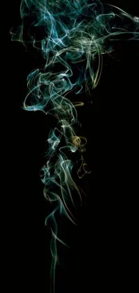 This abstract live wallpaper captures the mesmerizing and haunting movement of green smoke against a black background