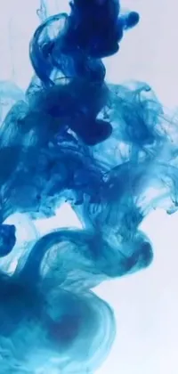 This phone live wallpaper showcases a mesmerizing close-up shot of a swirling blue substance in water