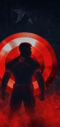 This live wallpaper for your phone features the iconic superhero, Captain America, standing heroically in front of a vibrant red light