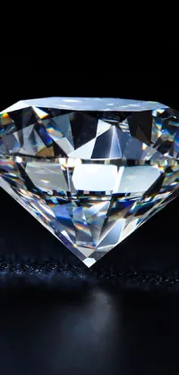 This stunning live wallpaper features a close up of a brilliantly sparkling diamond sitting atop a sleek black surface