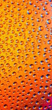 This live phone wallpaper features a close-up photograph of water droplets on a glass surface