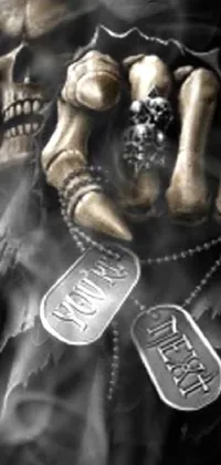 This live phone wallpaper features a close-up of a dog tag held by a figure, set against an intricate gothic background