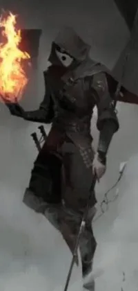 A phone live wallpaper depicting a mysterious man standing in the snow with a fire, clothed in stealth armor