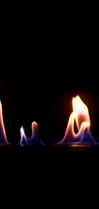 This live wallpaper features a stunning digital art piece of a close up of a fire against a black backdrop