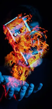 Transform your phone background with this stunning live wallpaper featuring an image of a camera releasing vivid flames