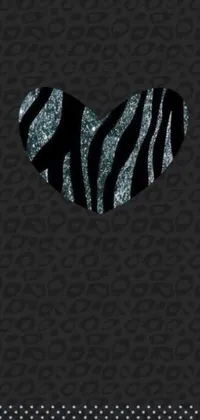 Enhance the look of your phone with a stunning live wallpaper that showcases a heart filled zebra print on a dark black backdrop