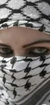 This phone live wallpaper showcases a stunning close-up of a person wearing a headscarf and a white muzzle