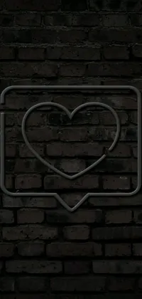 Looking for a stylish and unique phone live wallpaper? Check out this heart-shaped design, featuring a black heart sign on a brick wall