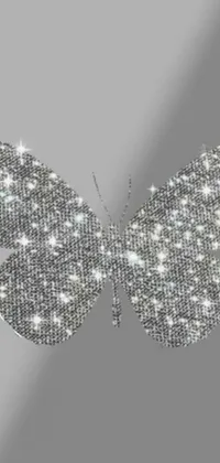 This phone wallpaper features a beautiful digital art of a metallic diamond butterfly on a gray backdrop