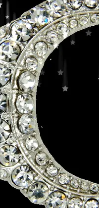 This phone live wallpaper boasts a luxurious diamond crescent brooch from Joe Bowler