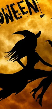 This phone live wallpaper features a lowbrow aesthetic with a black silhouette of a witch riding a broom in front of a bright full moon, creating an eerie and spooky vibe
