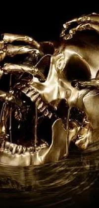 This elegant live wallpaper depicts a detailed, close-up image of a gold skull floating in water