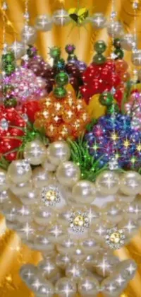 This stunning live wallpaper features a vase of colorful flowers surrounded by glittering ornaments, pearls, beads and crystals
