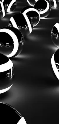 This dynamic live wallpaper features a striking composition of black and white spheres stacked on top of each other