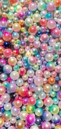 This phone live wallpaper is a stunning display of colorful balls neatly stacked on a table and surrounded by sparkling effects, adding a touch of glamor to the background