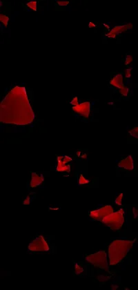 This vibrant live phone wallpaper features a bunch of red rose petals floating on a black background