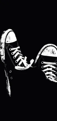 This black and white live wallpaper features a pair of sneakers captured on an iPhone and stylized using sots art for a propaganda poster look